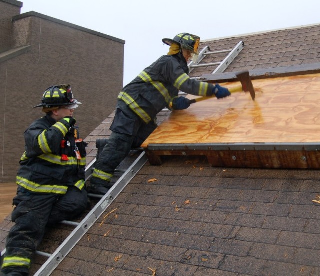 September 27, 2009: Probationary FF Kiev Monferrari trys his hand at venting with the axe while FF Pete Silveira looks on.